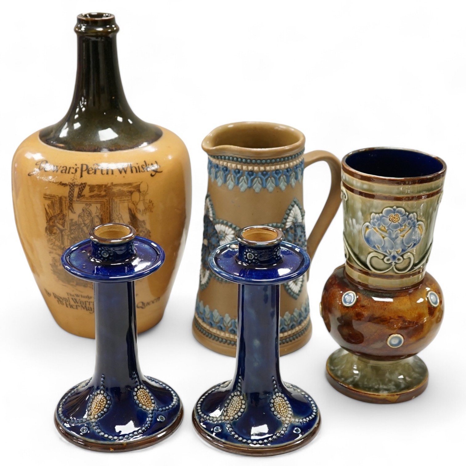 A Doulton Lambeth Dewars Perth whisky flagon, a pair of candlesticks and two other pieces, tallest 29cm. Condition - mostly good, one or two small chips